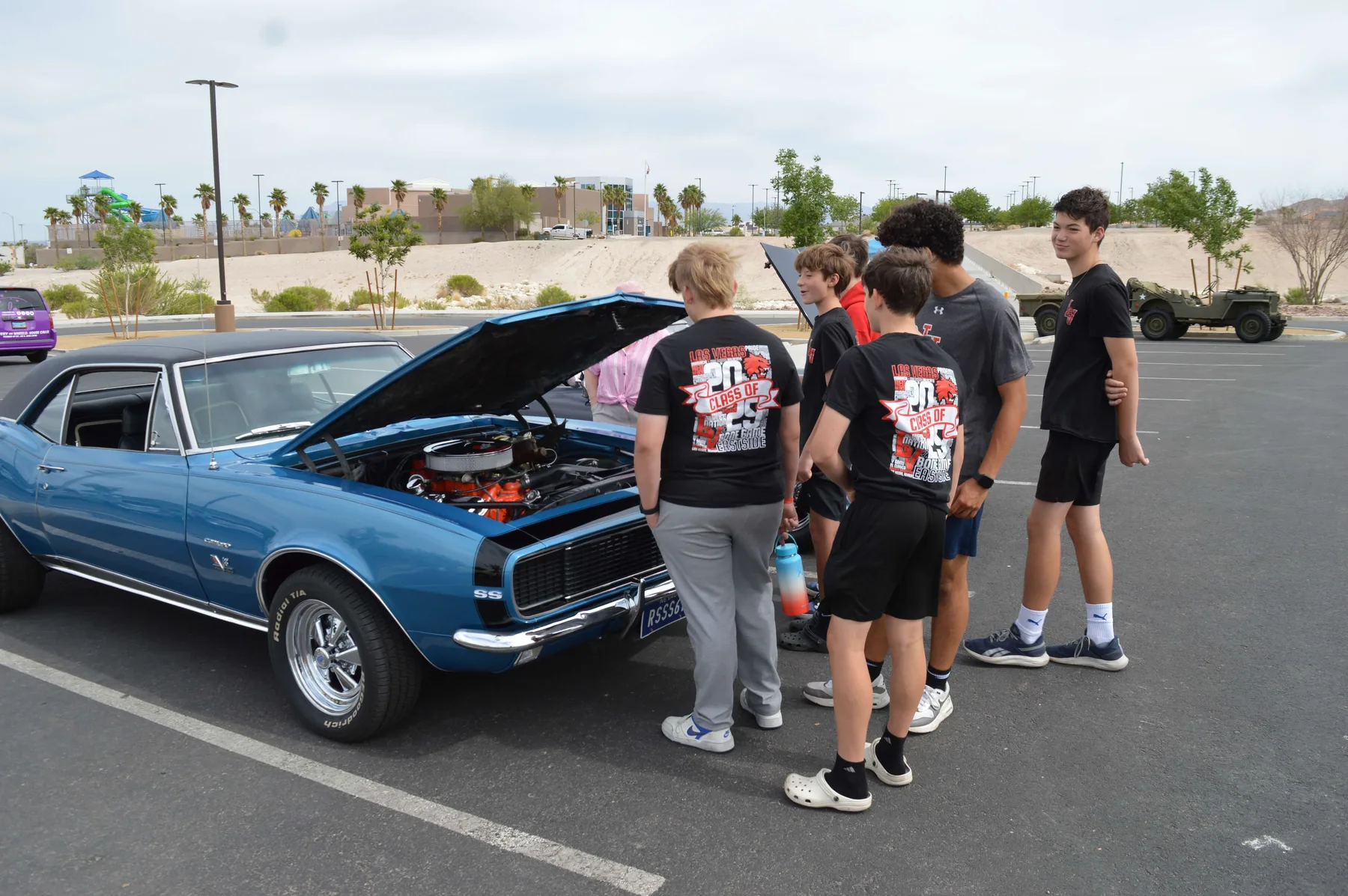 Visitors gathered around a blue classic car at the 2025 car show